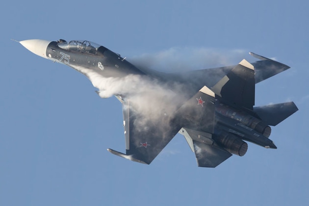 Condensation pours off a Flanker-C during a high-energy move. (Phil Hosking)