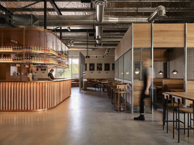 The copper bar is the centrepiece of Beth&rsquo;s Bar at Four Pillars' expanded distillery, complemented by warm Blackbutt timber throughout. (Image credit: Anson Smart)