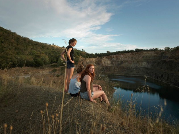 The girls, 2017 by Tamara Dean. A tight-knit group of teenage girls from regional south-west NSW look out over a local quarry on the outskirts of town, a place where local teens cool off in the heat of summer. Extending on my 2013 series The Edge, this image is part of a series exploring the relationship between young people and nature in contemporary regional life. Having photographed these girls in a number of locations, I was struck by their fearless, playful, adventurous spirits, a result of them growing up on the land. This project was initiated and commissioned by The Wired Lab.