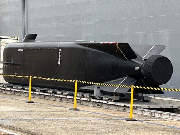 A Ghost Shark extra-large autonomous undersea vessel (XL-AUV)&nbsp;on a Fleet Base East wharf alongside a shipping container and LHD HMAS Adelaide.

Credit: Julian Kerr