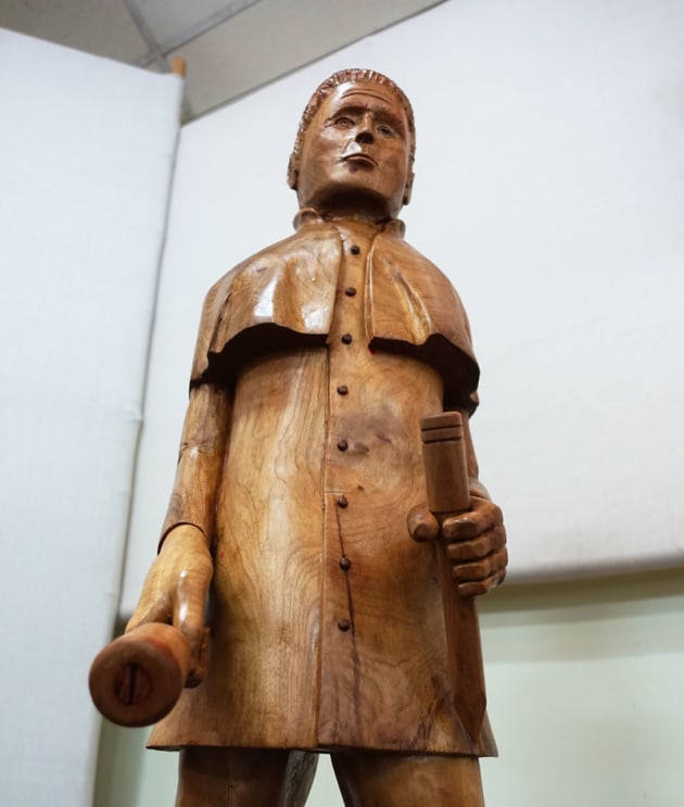 Tom Black, The Mason, white beech, red cedar. "The Mason is a tribute to several ancestors who were masons and cabinetmakers. Masons were the multi-skilled designers and builders of their era. Evidence of the quality and longevity of their work is all around us. With todays technology many professions and trades have taken the place of the masons and the hope is that this carving will briefly illustrate their worth."