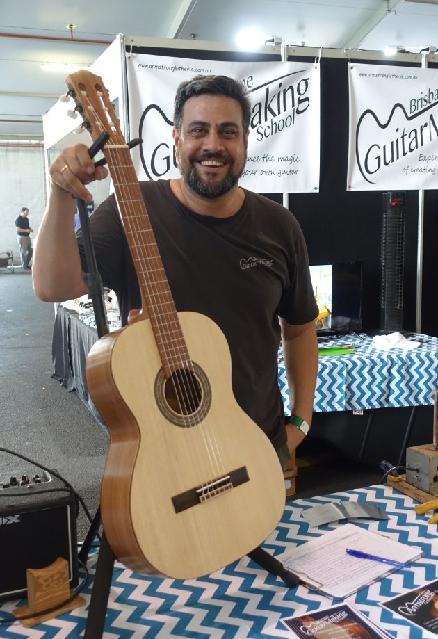 Trent Palelei of Brisbane Guitar School with a silver quandong and blackwood beauty. They teach people how to make their own instrument.