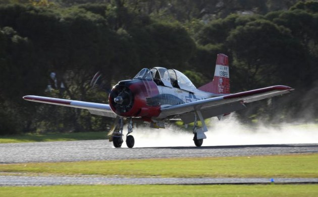 The Sunday afternoon rain left pilots facing a wet runway. Not the spray coming from this T-28 Trojan as the wheels touch the runway. (Steve Hitchen)