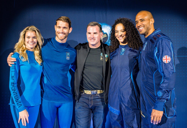 Under Armour Founder Kevin Plank stand with models wearing the UA-designed base layer and spacesuit - 2019
