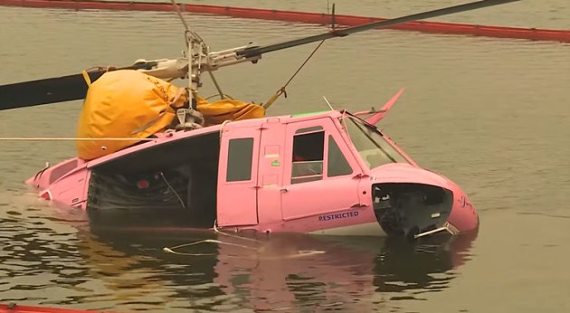Huey VH-ONZ is recovered from the dam. (still from Department of Defence video)