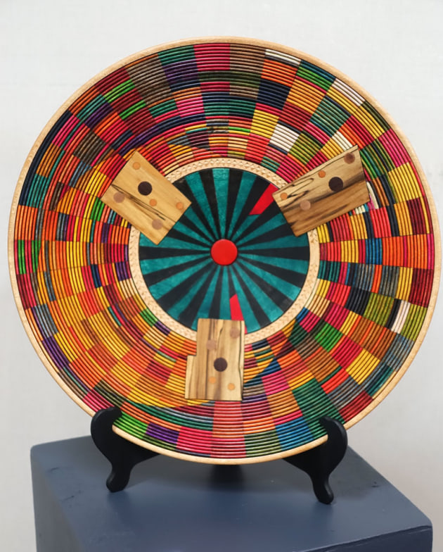 Vince Rush, Dawn at Laura Station, jacaranda.
"This platter is an attempt at capturing the thrill and colour of an inland dawn at Barcaldine Queensland 2018. A cold dark night turns into the warmth and colour of sunrise over the rippling waters of the wetlands at Lara station. Jacaranda was turned with 33 beadings, then chip carved and coloured with inks and finished."
