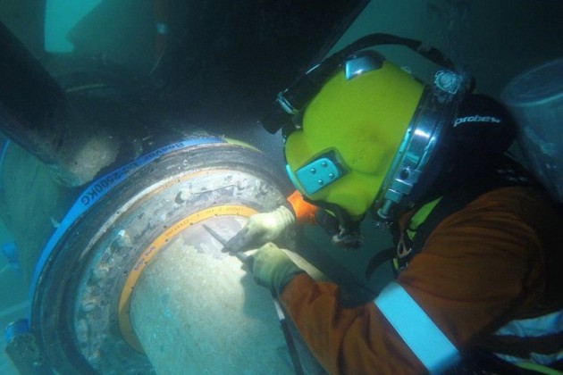 A diver from commercial diving company Neptune Marine Services works on replacing the A bracket bearings in HMAS Parramatta. This was the first time such a task has been undertaken without the ship being removed from the water. Navy Daily