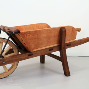 Myles Gostelow, A Barrow to Push, silky oak, elm, claret ash. 'This timber wheelbarrow was inspired by, and pays tribute to, the early work of Charles Weston and the role he played in greening the Nation&rsquo;s Capital between 1911&ndash;1926. Charles Weston was an English-born horticulturalist and in all, Weston was responsible for the planting of two million trees and shrubs in Canberra during this time.
