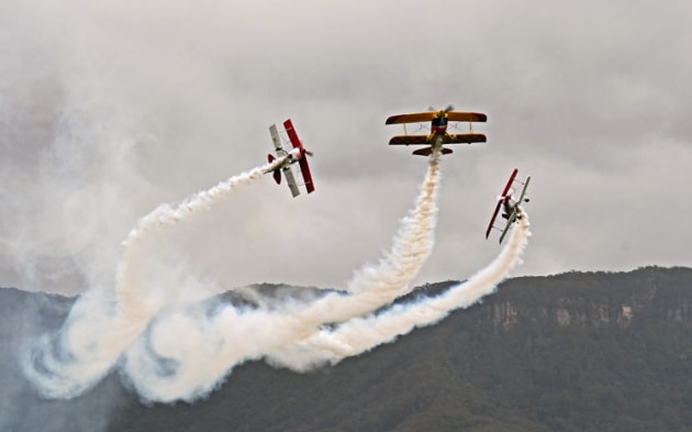 Two Pitts cross behind the Wolf Pitts as the Sky Aces present their aerial ballet. (Steve Hitchen)