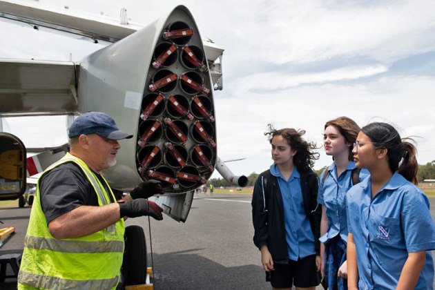 An engineer from the Historical Aircraft Restoration Society shows students some of the finer points of the Grumman Tracker. (TBA)