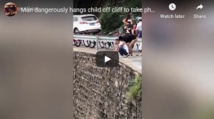 Man dangles small boy over cliff for "unique" photo