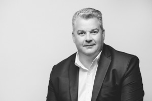 ASSOCIATION MERGER COMPLETE WITH NEW BOARD, AITKEN PRESIDENT